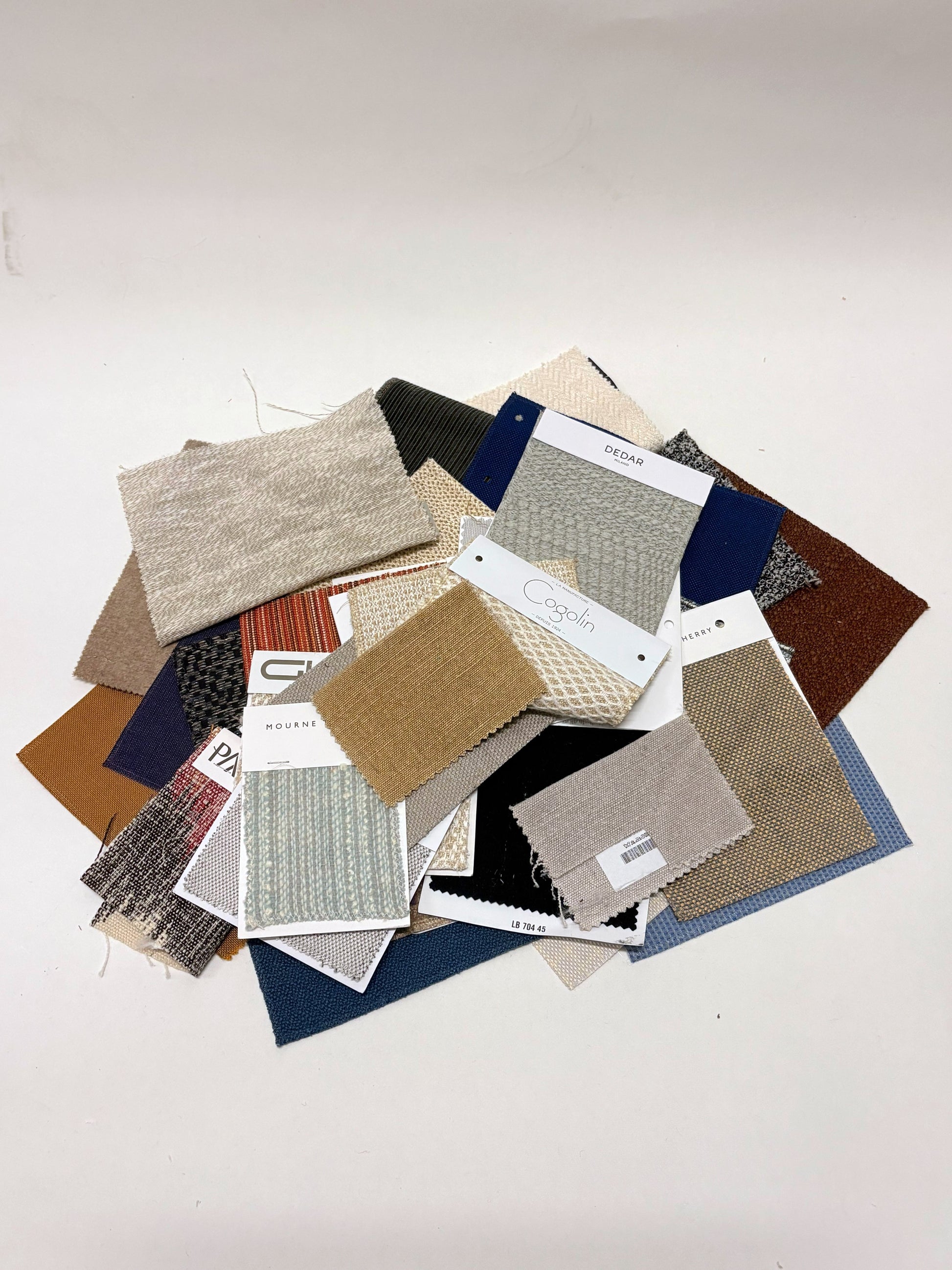 Collection of fabric swatches with various patterns and colours