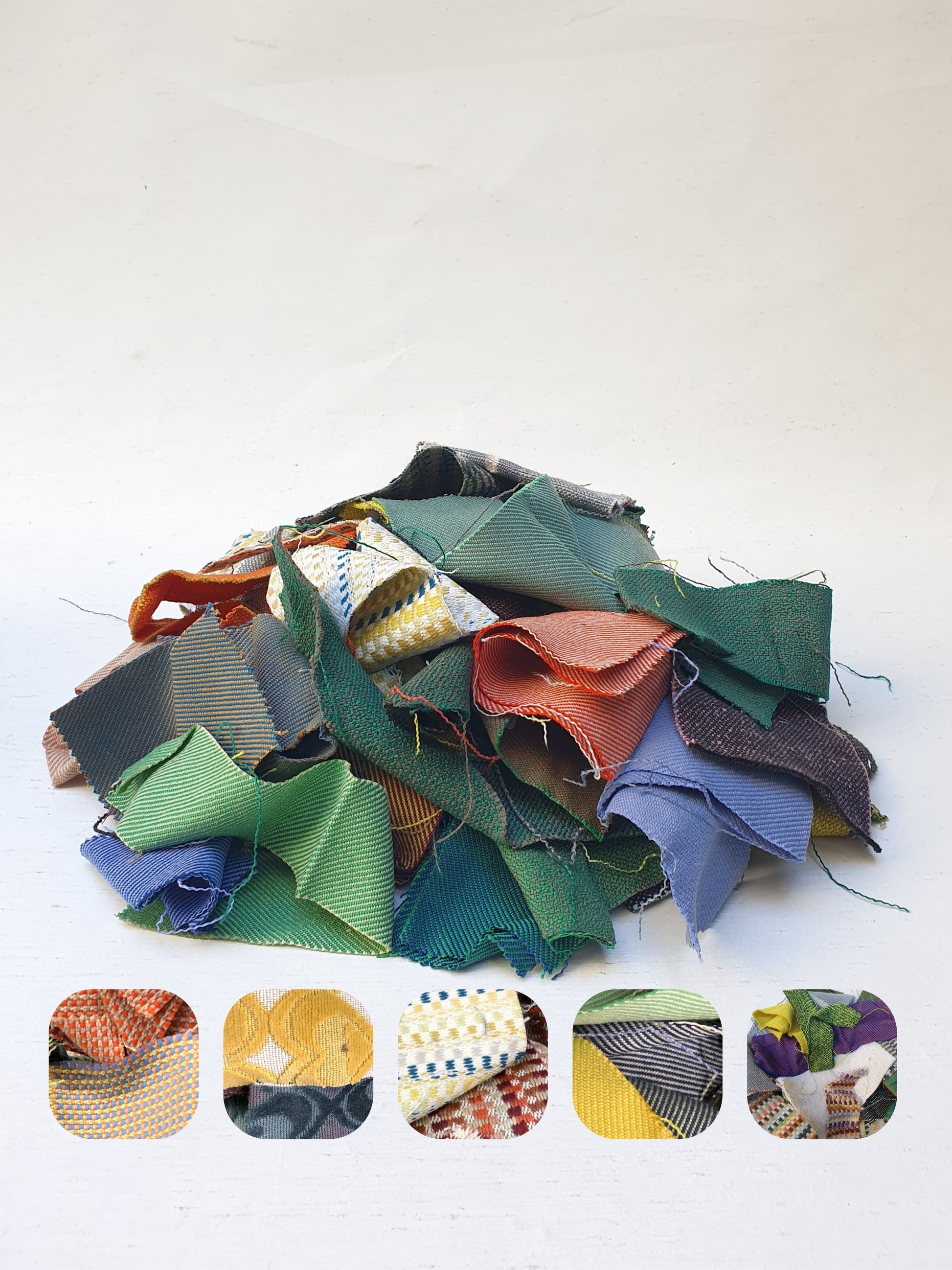 A pile of various rectangular fabric offcuts in different colours and textures.