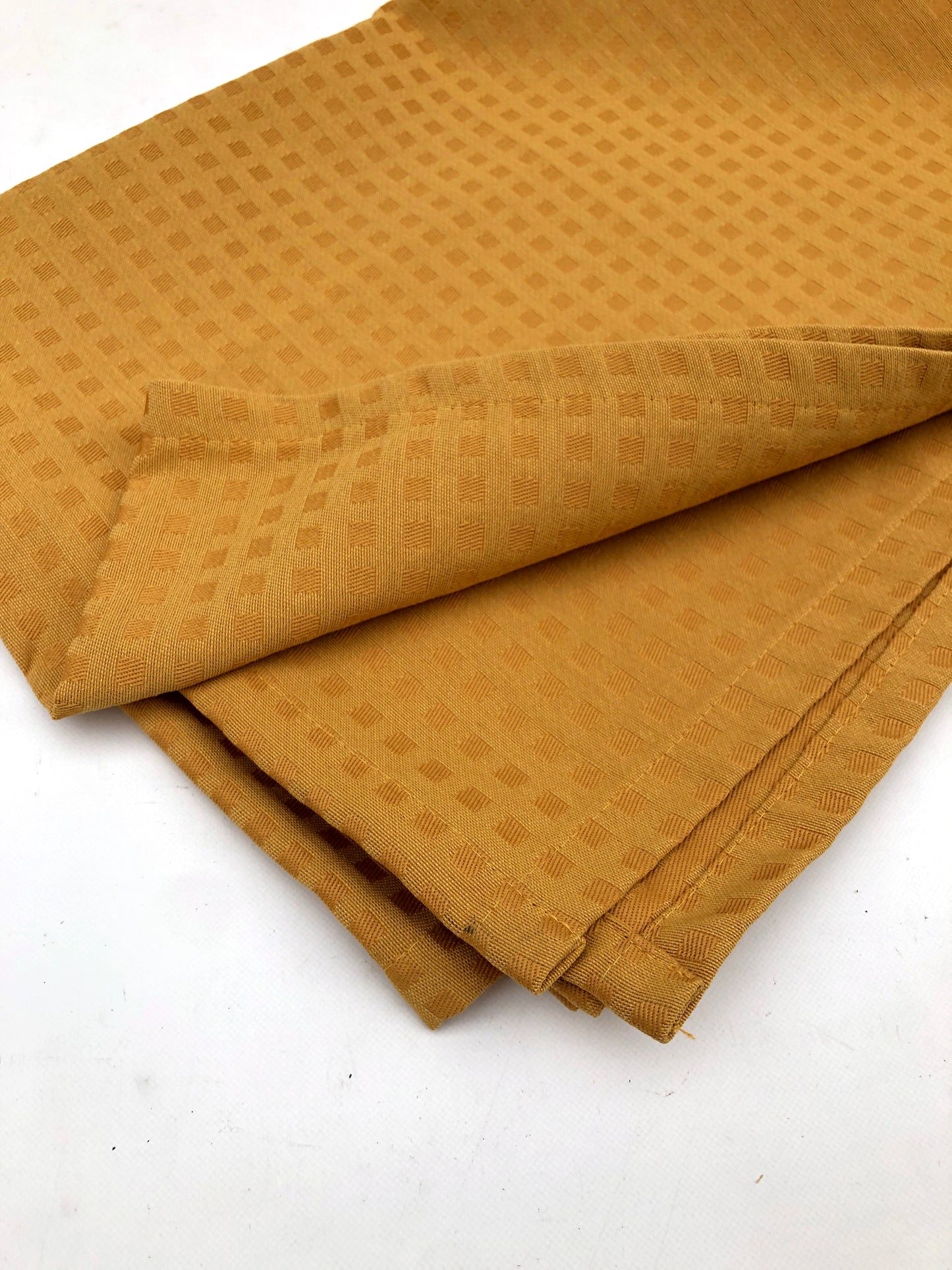 Table runner fabric in mustard yellow with chequered patterns