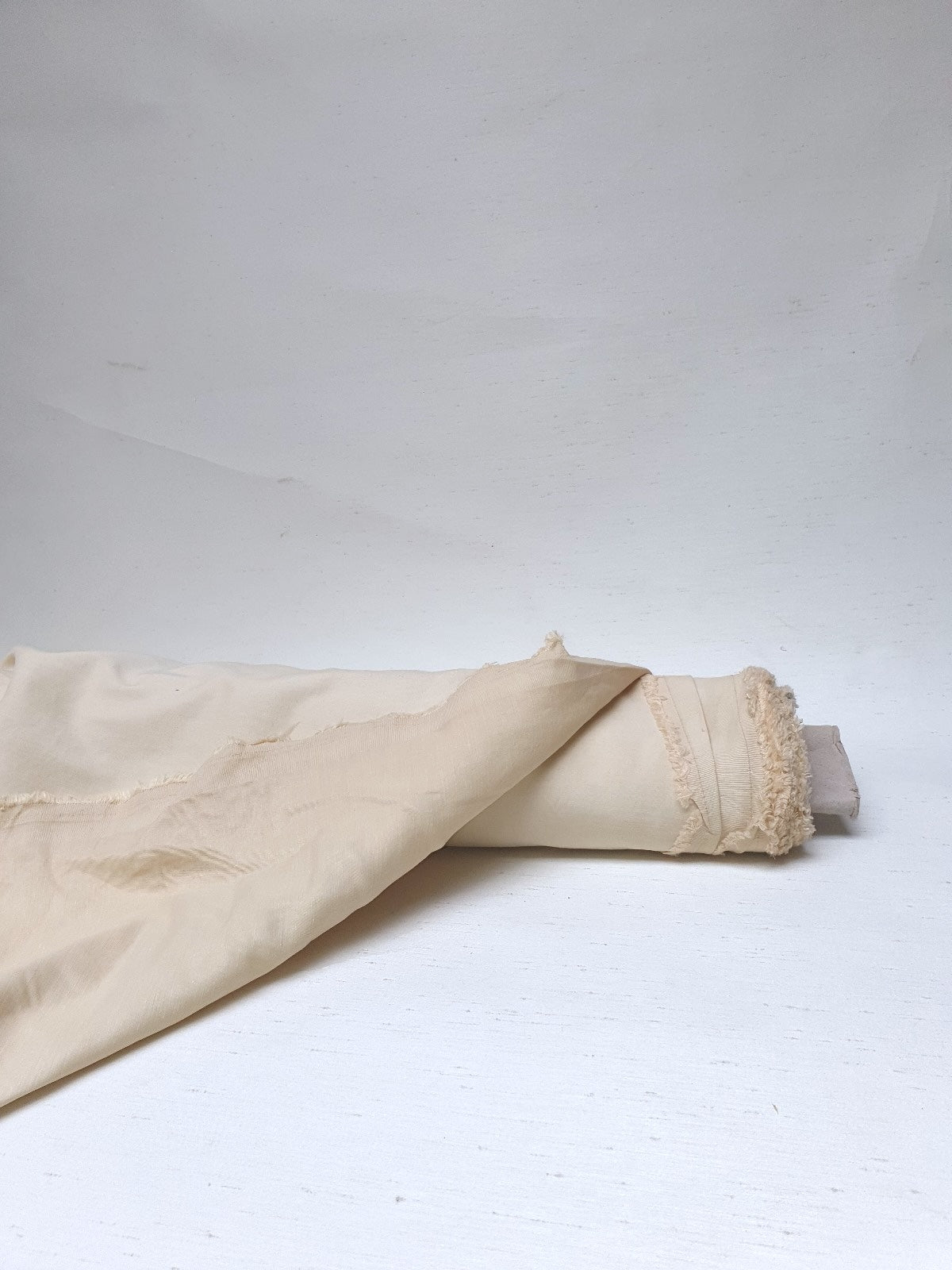 Close-up of a yellow-cream medium-weight taffeta fabric with a soft textured 