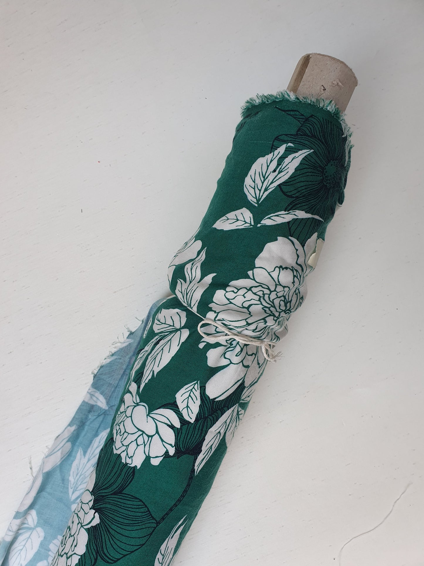 A green twill rolled fabric with a floral print 