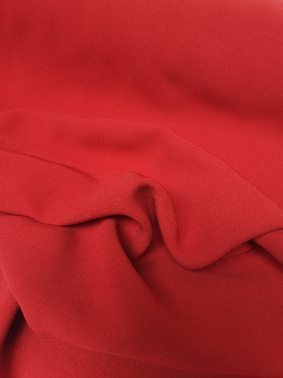 Close-up of red twill rolled fabric  