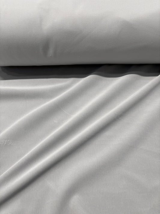 Close-up of rolled silver grey velvet fabric 