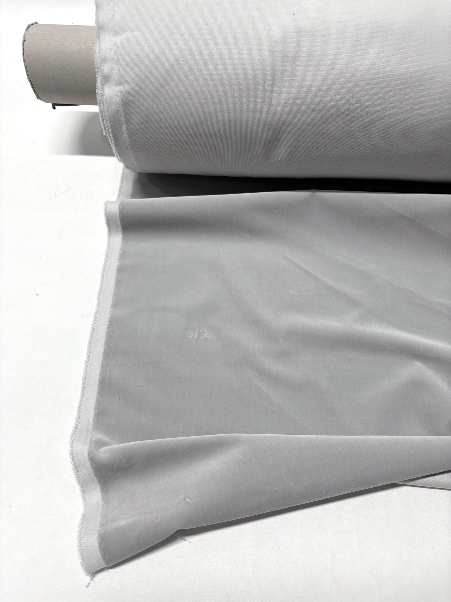 Close-up of rolled silver grey velvet fabric 