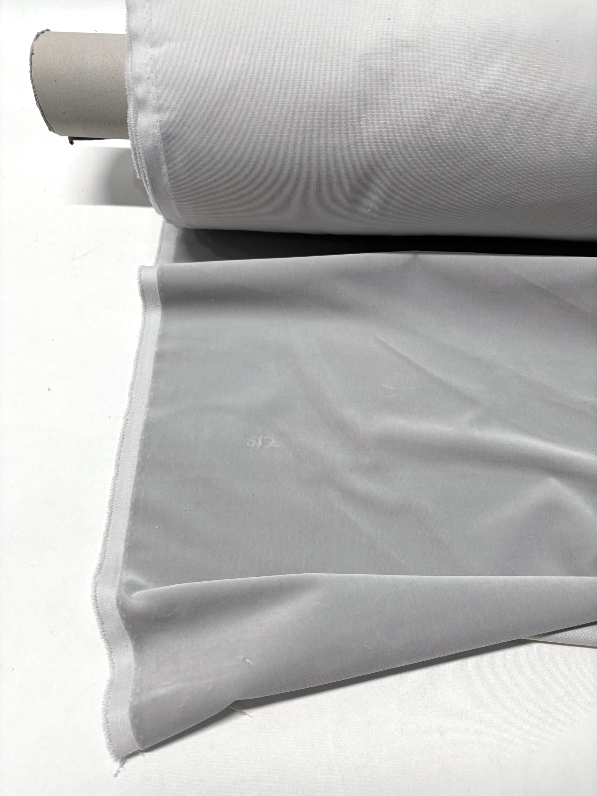 Close-up of rolled silver grey velvet fabric 