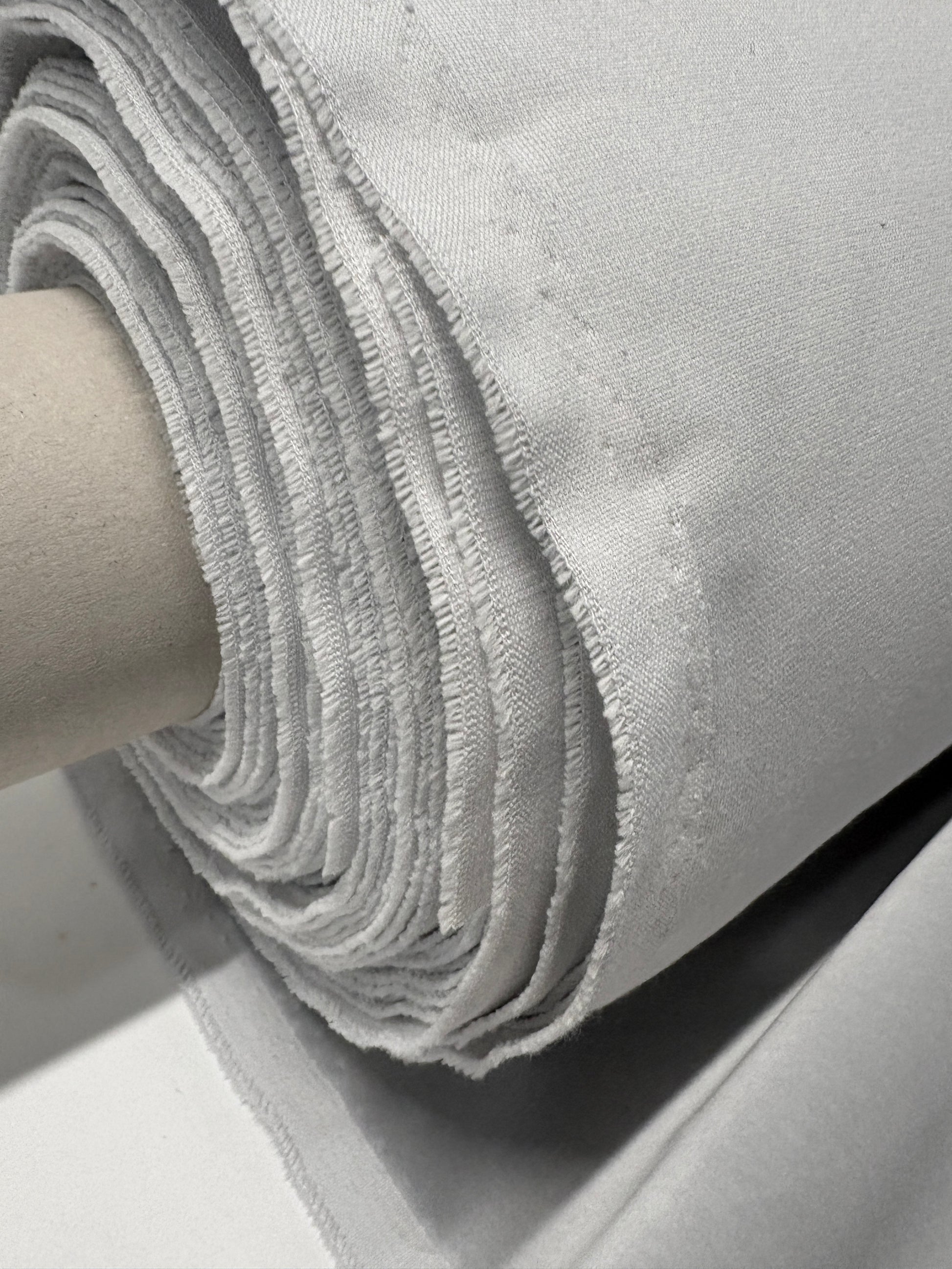 Close-up of rolled silver grey velvet fabric 