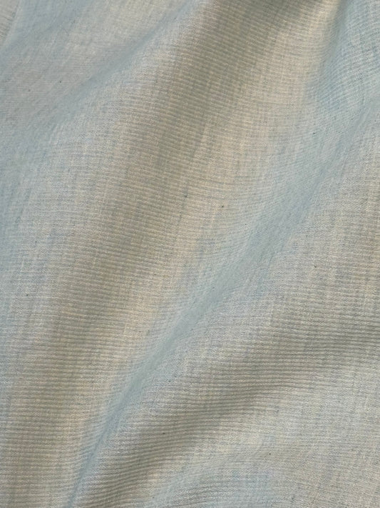 Close-up of pique organic-cotton fabric in light-mottled green 