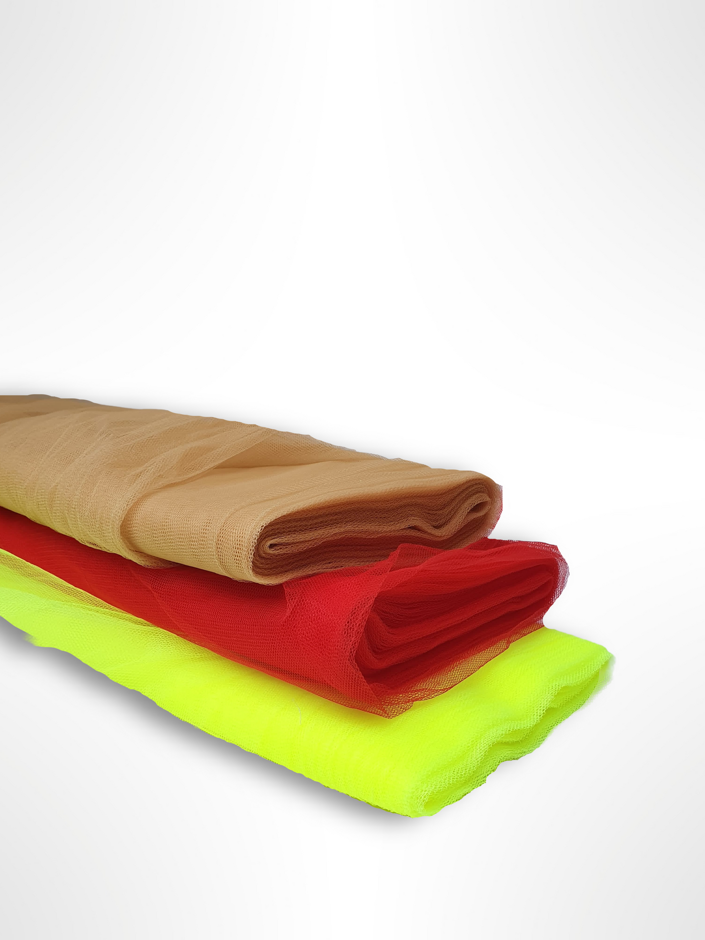 A close-up of voile tulle fabric in neon yellow, cinnamon, and red
