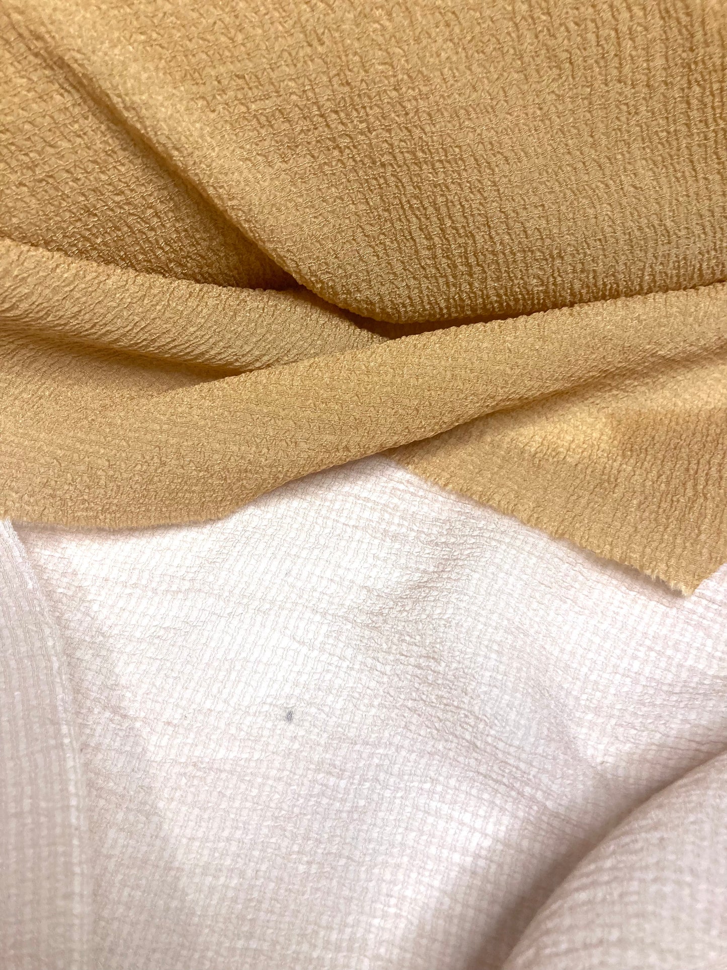 A close-up of wrinkled fabric in a cinnamon colour, showing the texture
