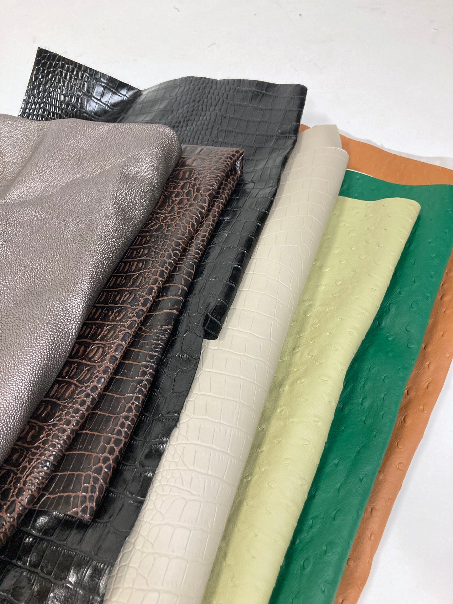 Close-up of a stack of faux leather with various colours and sizes 
