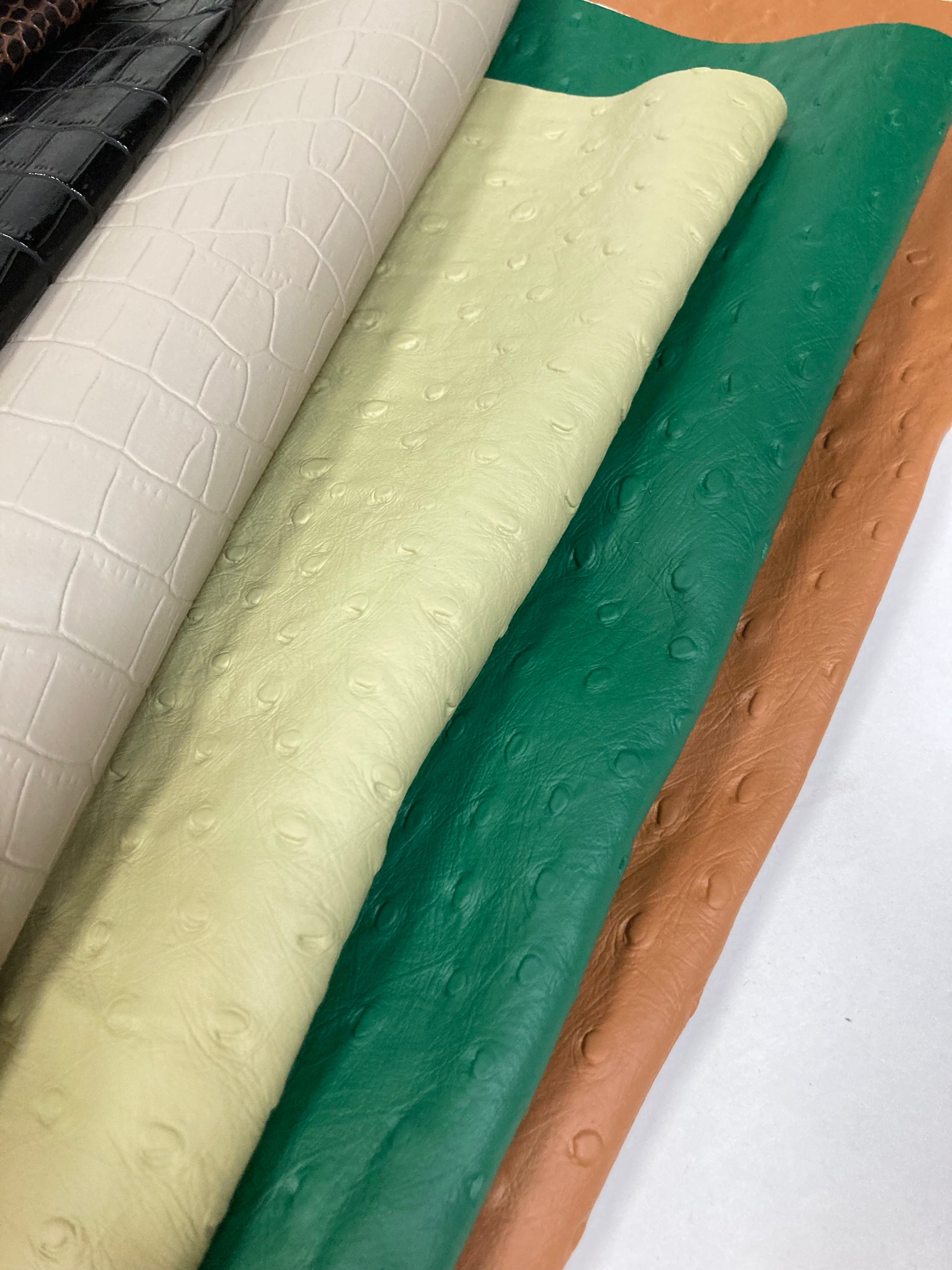 Close-up of a stack of faux leather with animal patterns
