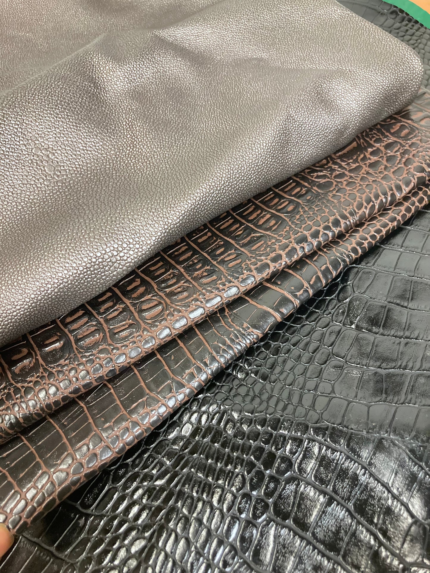 Close-up of a stack of faux leather with animal patterns