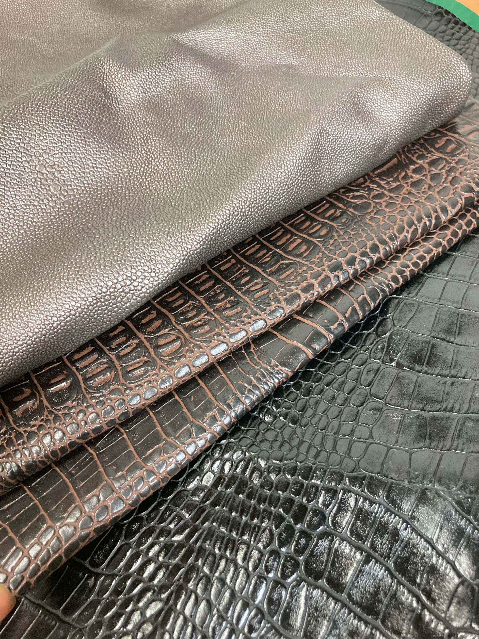 Close-up of a stack of faux leather with animal patterns