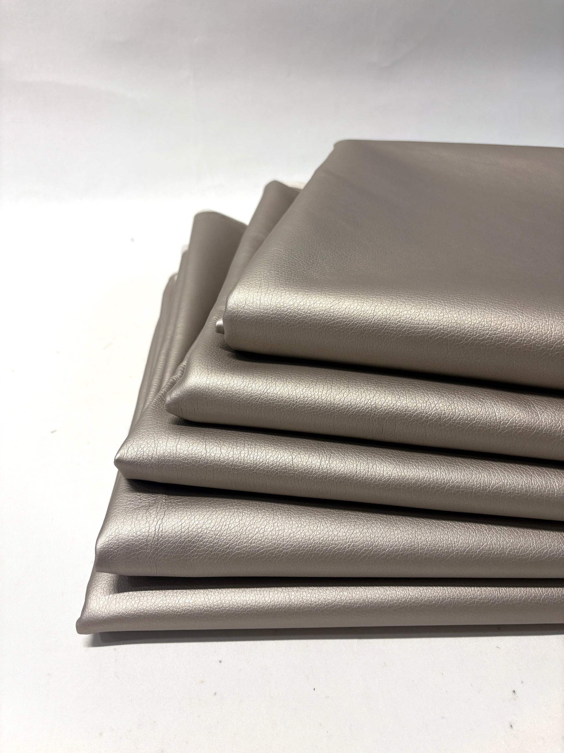 Stack of faux leather in metallic bronze