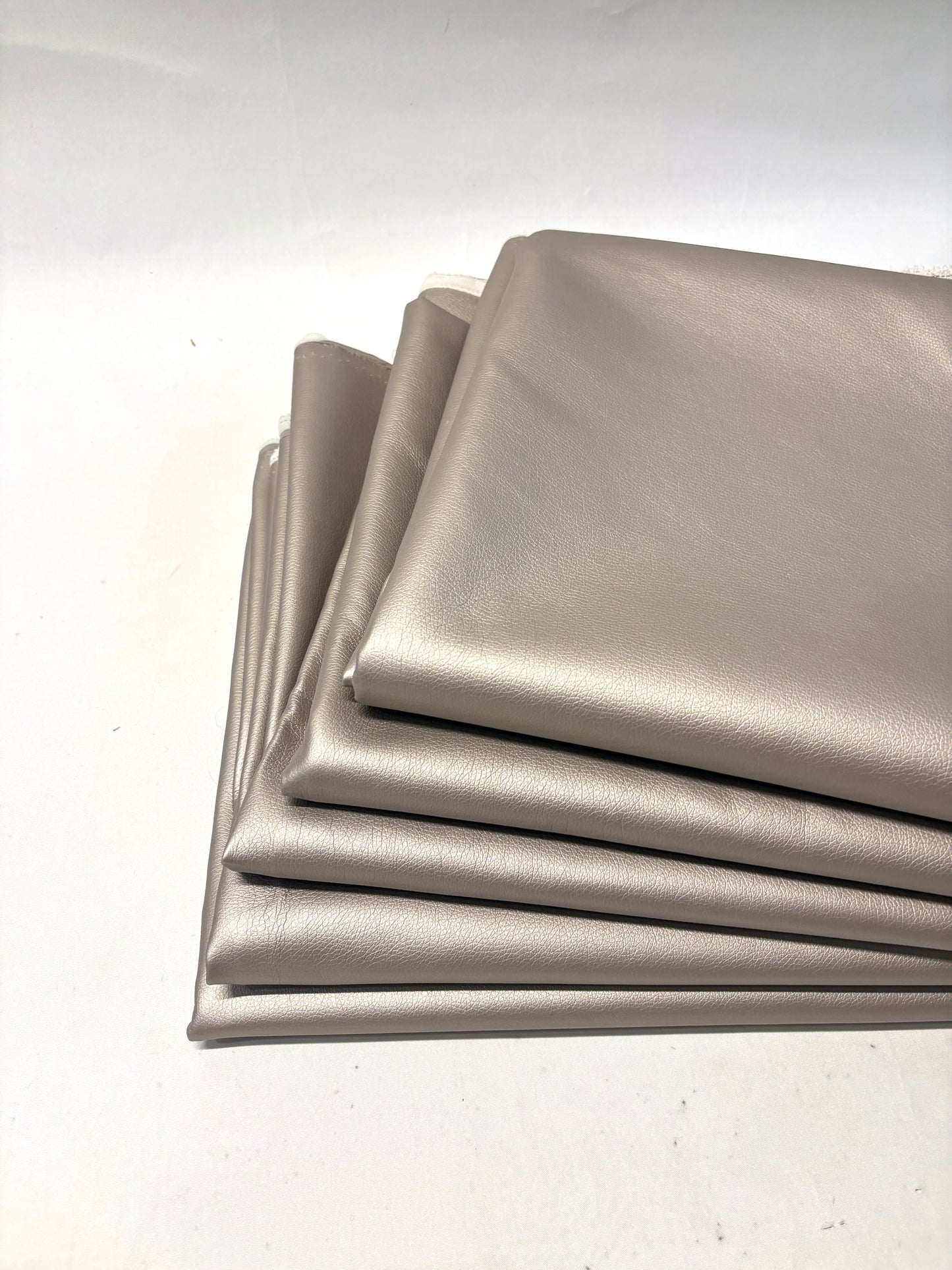 Stack of faux leather in metallic bronze 