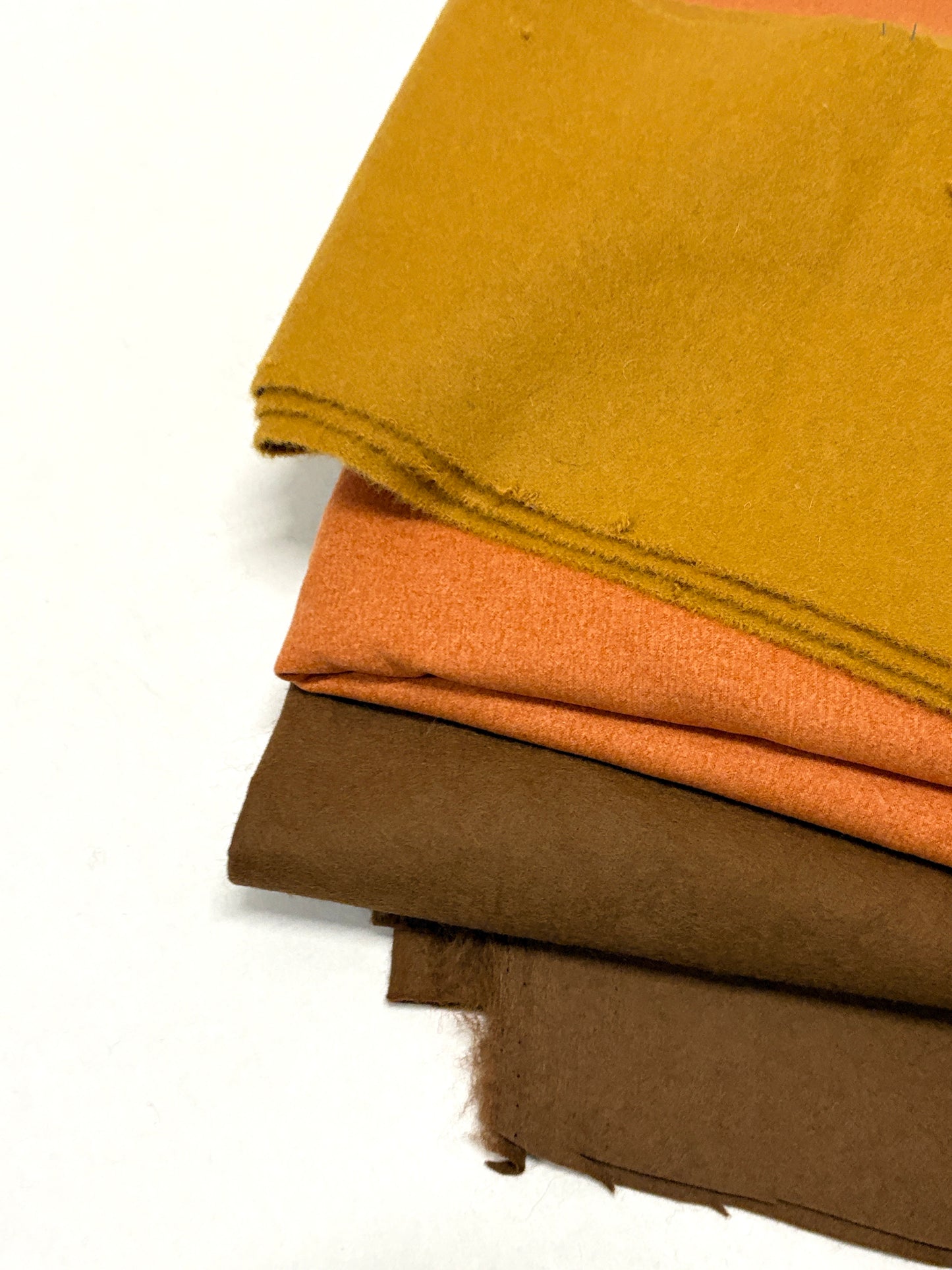 Three felt fabric in yellow, orange, and brown