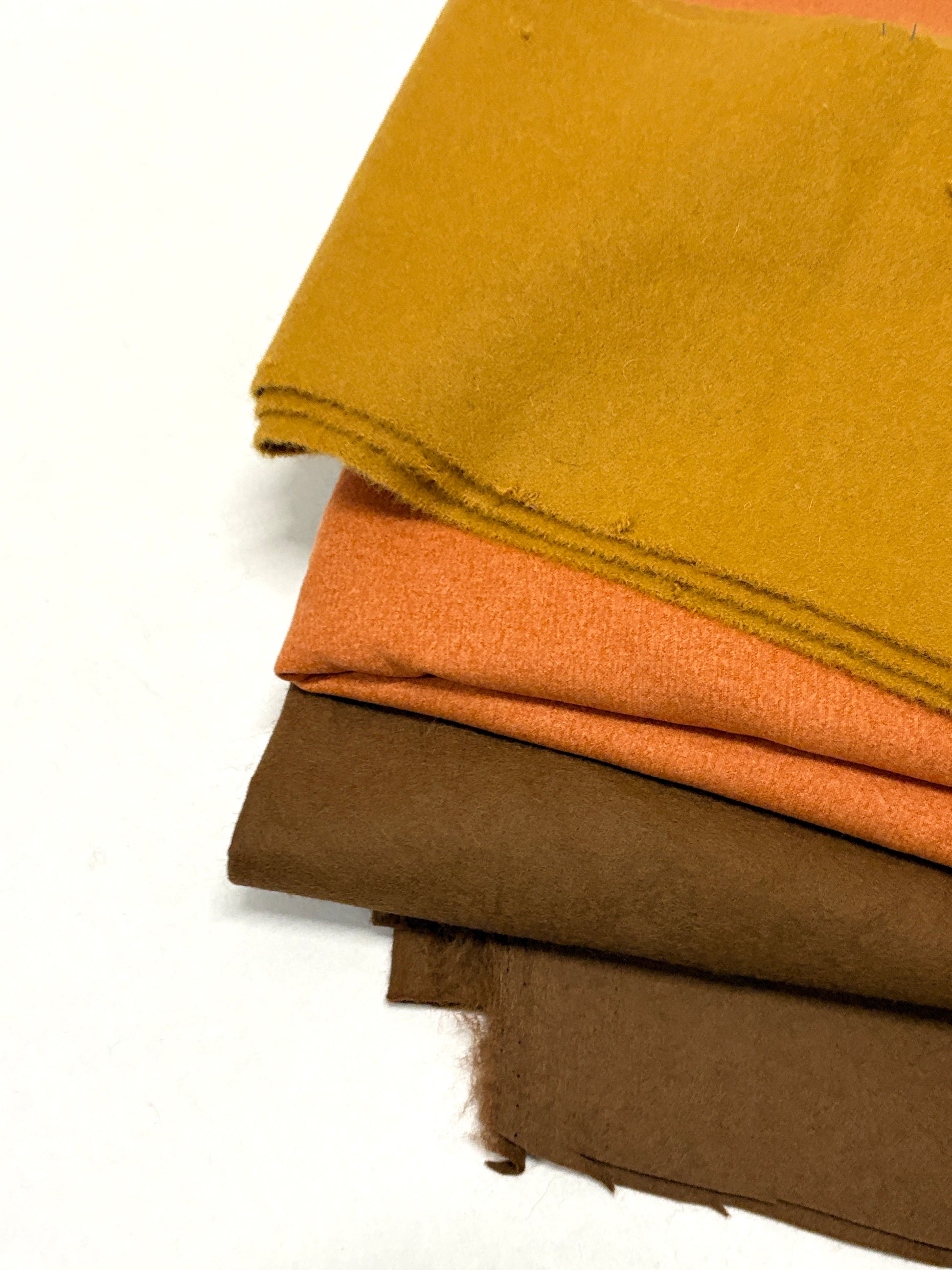 Three felt fabric in yellow, orange, and brown