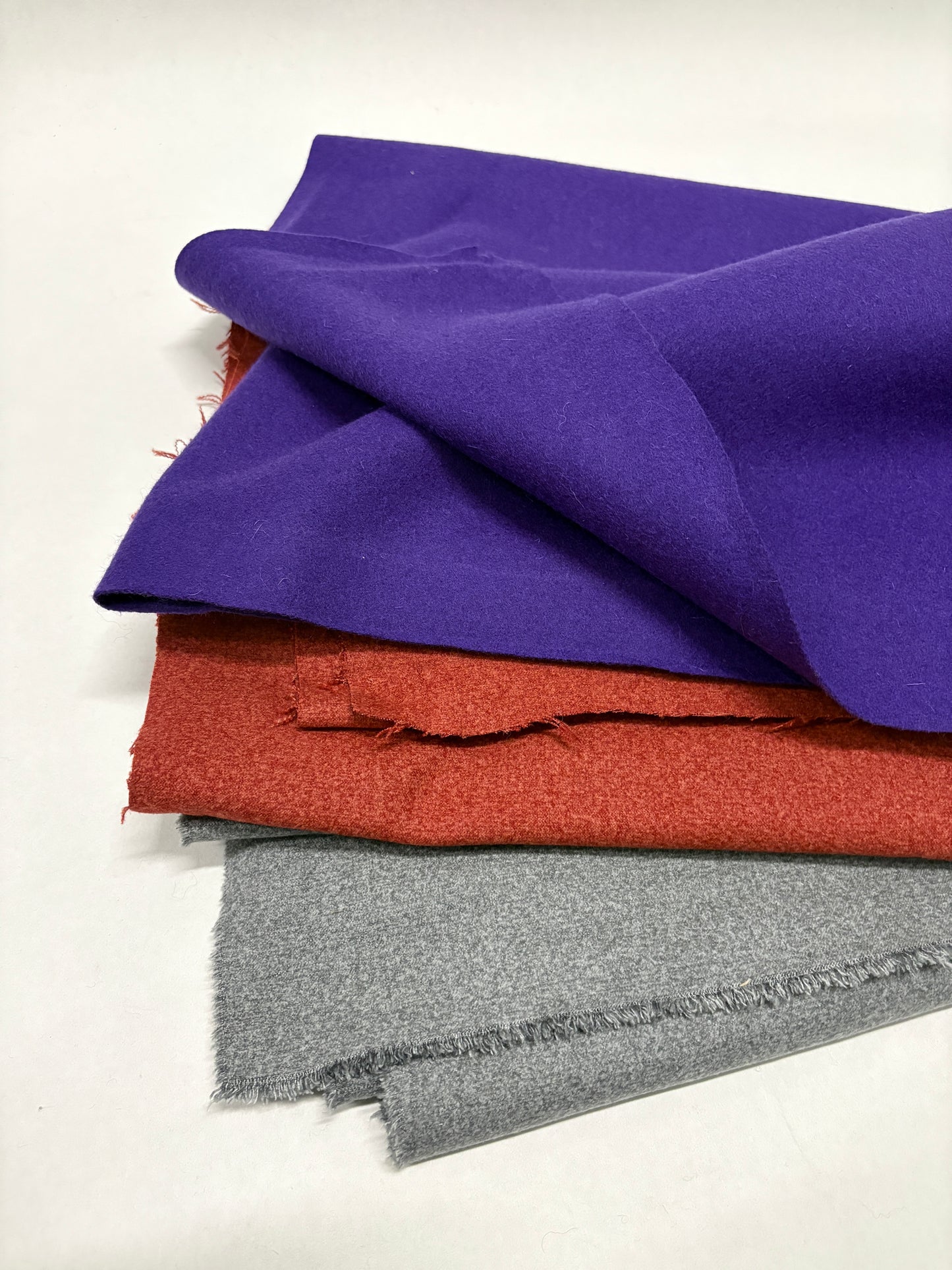 Three felt fabric in purple, red, and grey