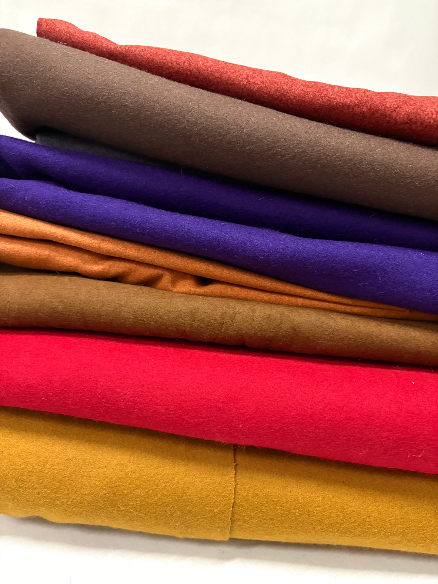 Stack of folded felt fabric in various colours