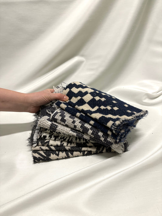 Collection of fluffy heavyweight fabric with various patterns in white, blue, and black 