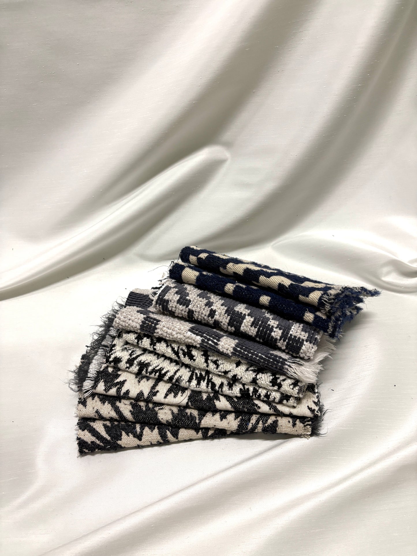 Collection of fluffy heavyweight fabric with various patterns in white, blue, and black 