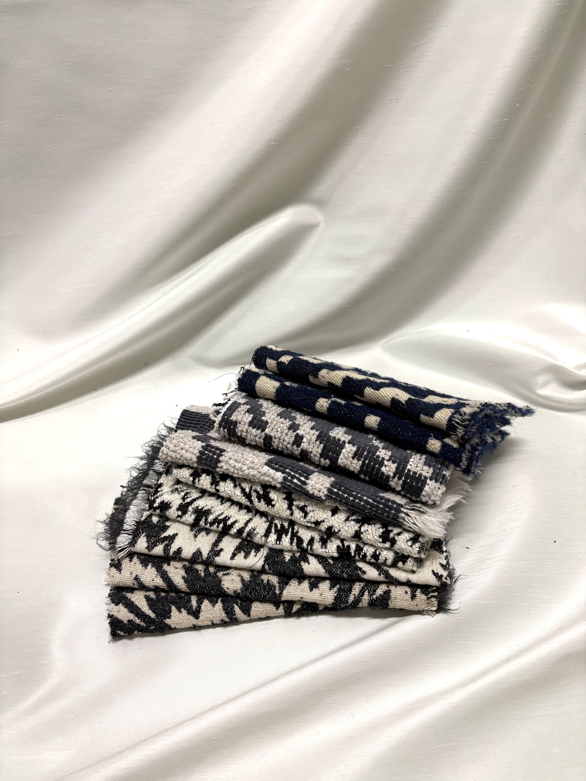Collection of fluffy heavyweight fabric with various patterns in white, blue, and black 