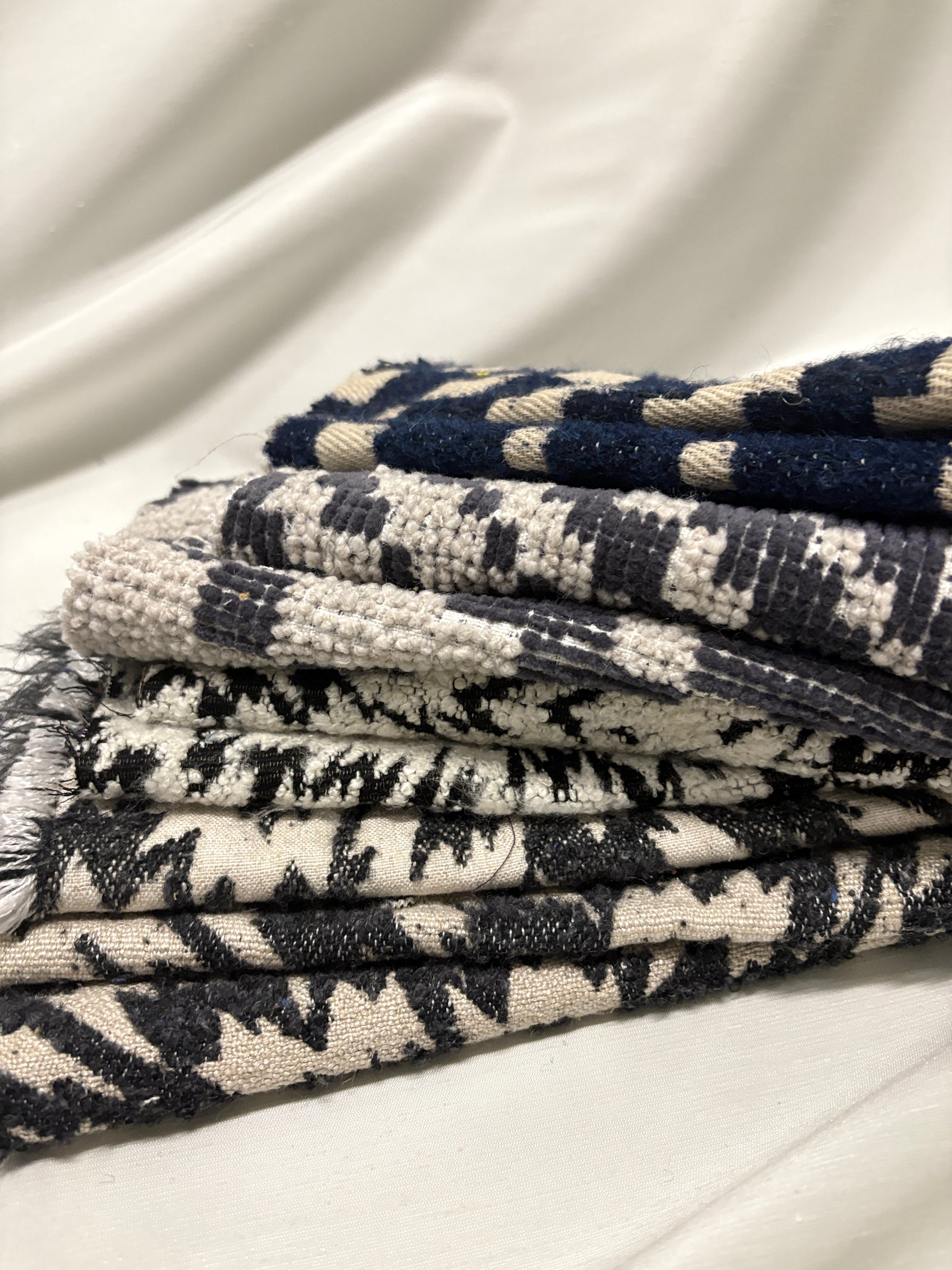 Collection of fluffy heavyweight fabric with various patterns in white, blue, and black 