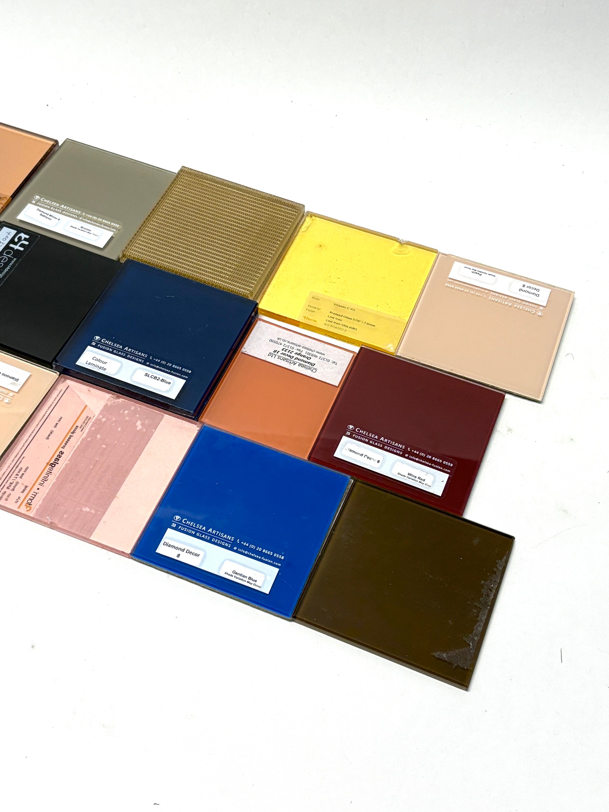 Collection of square colourful glass samples with various patterns 