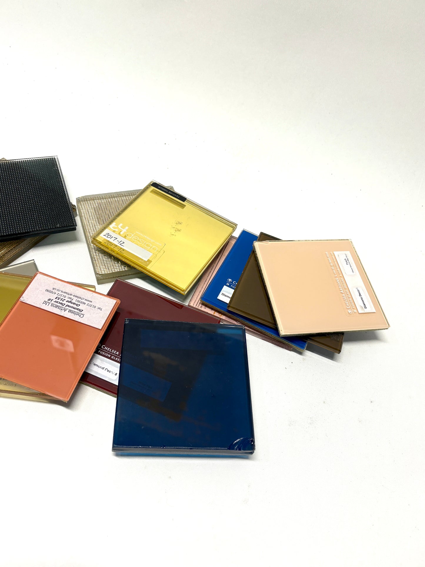 Collection of square colourful glass samples 