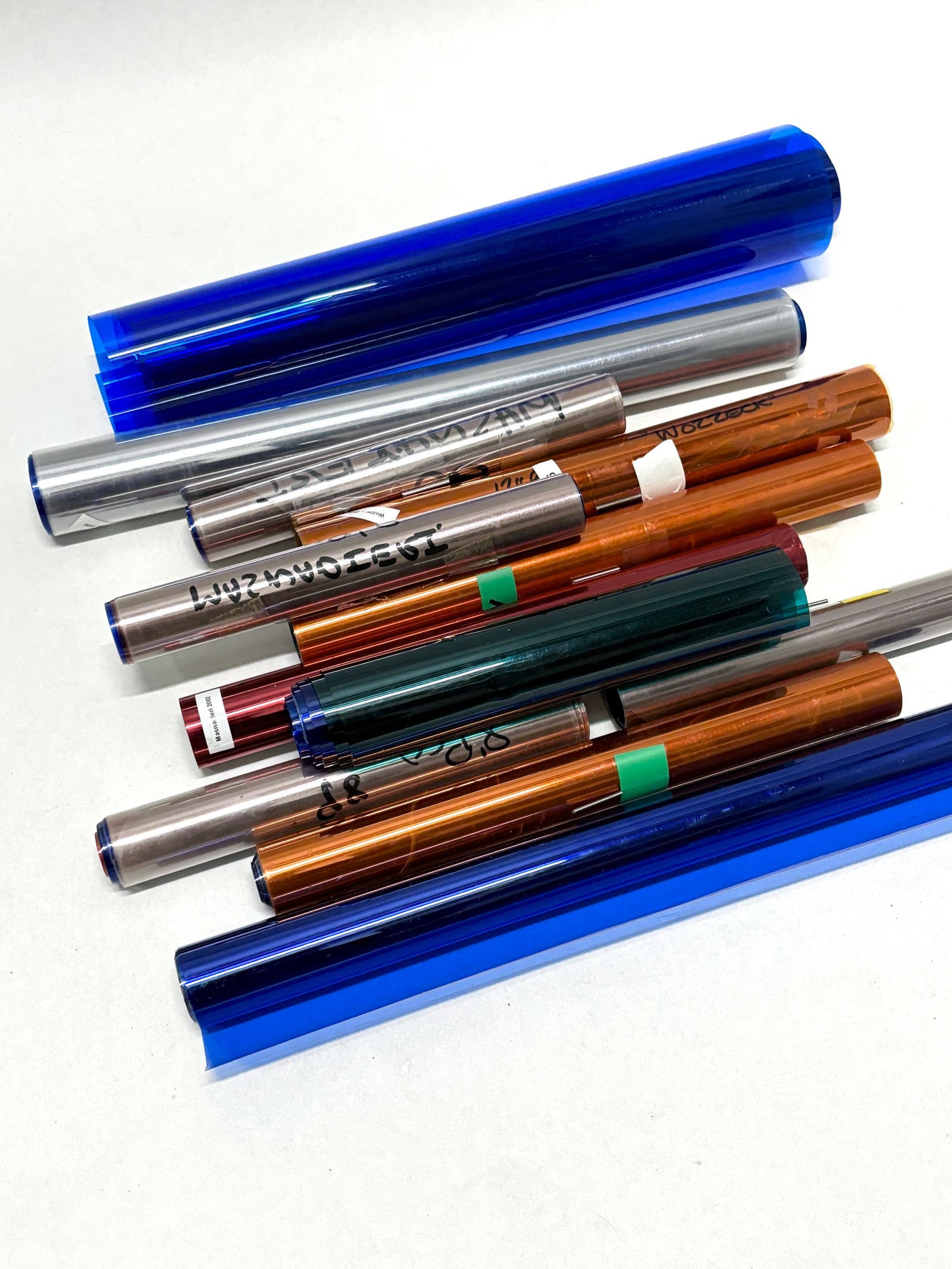 Collection of colourful glossy paper plastic rolls 