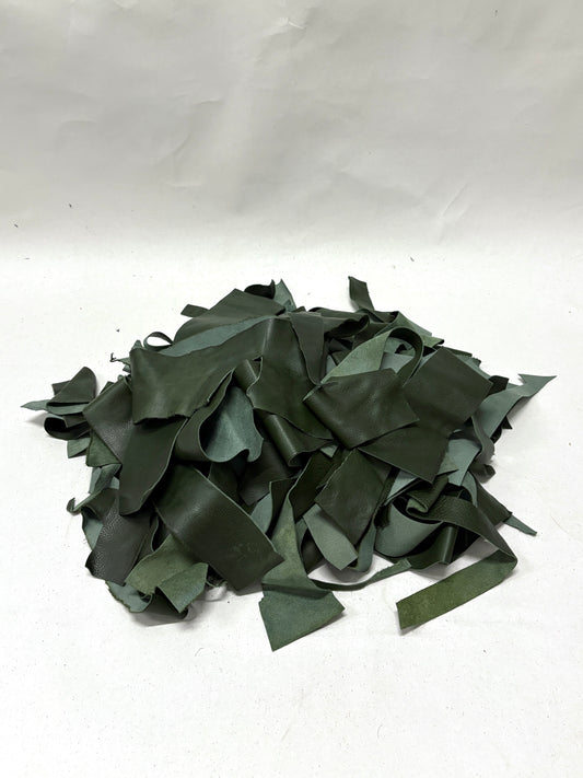 Pile of dark green leather offcuts in various sizes 
