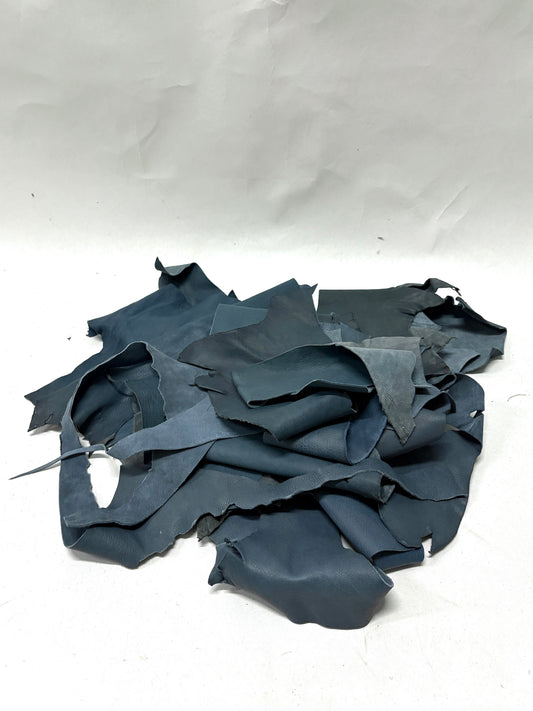 Pile of foggy blue leather offcuts with various sizes 