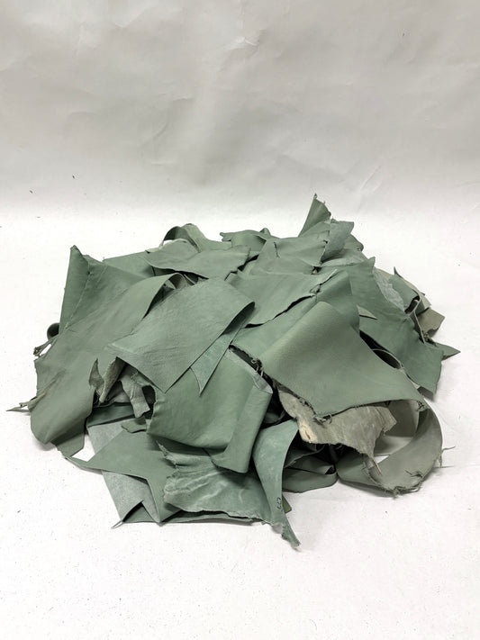 Pile of mint green leather offcuts with various sizes 