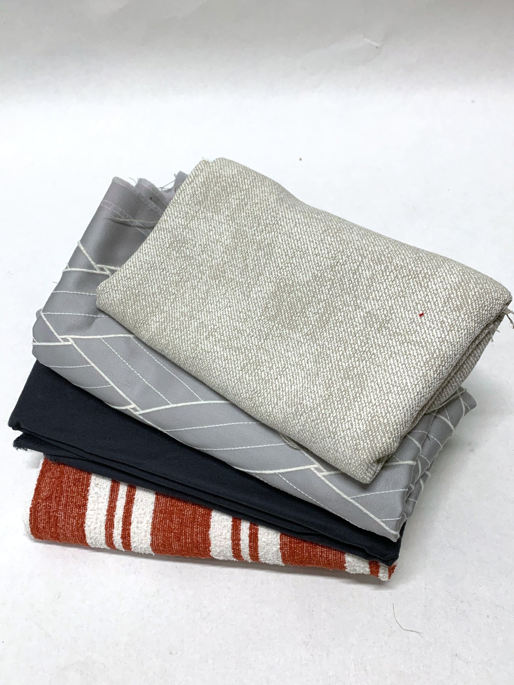 Pile of heavy weight fabric with various patterns and colours 