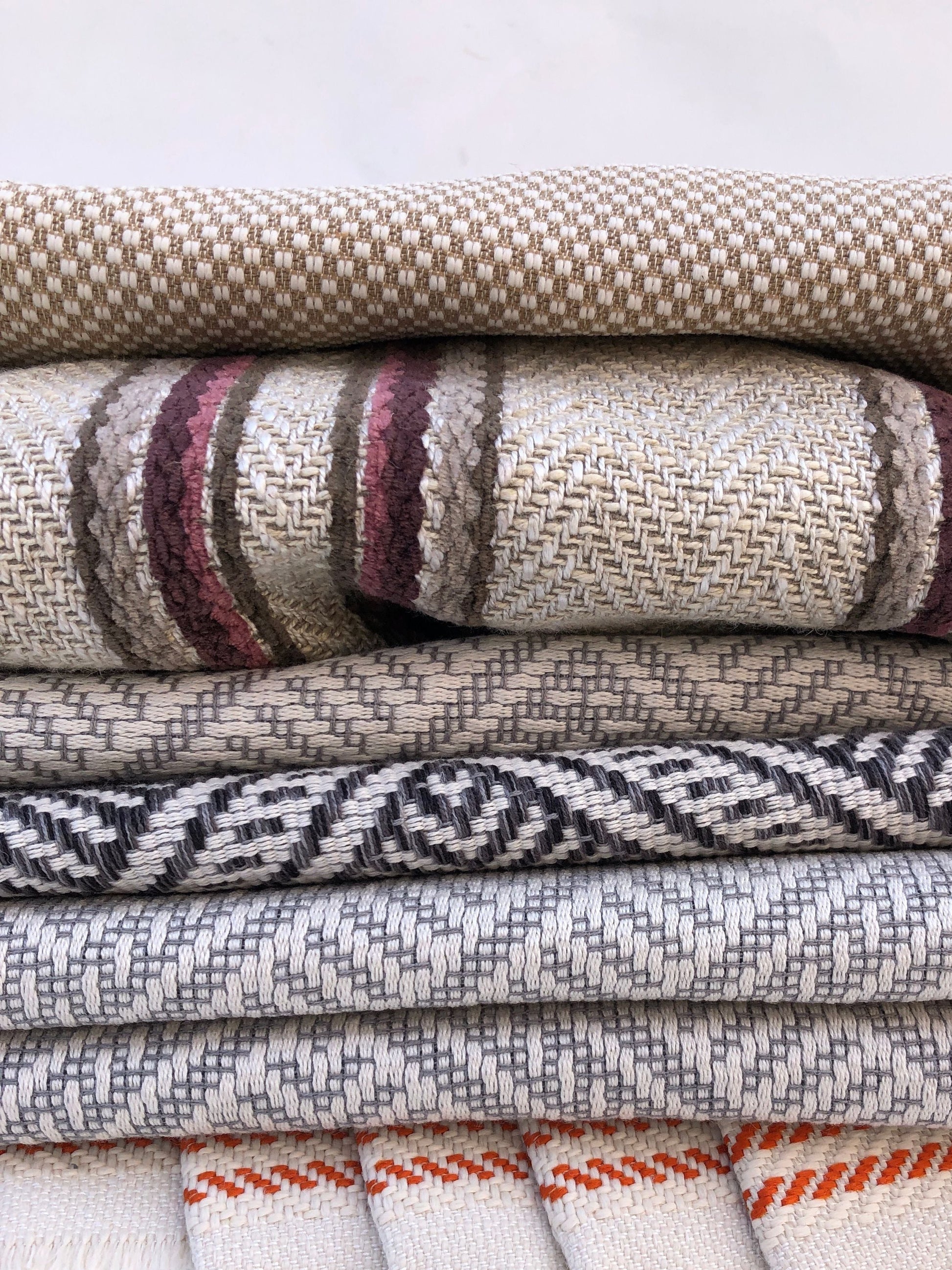 Close-up of a pile of heavy weight fabric with various patterns