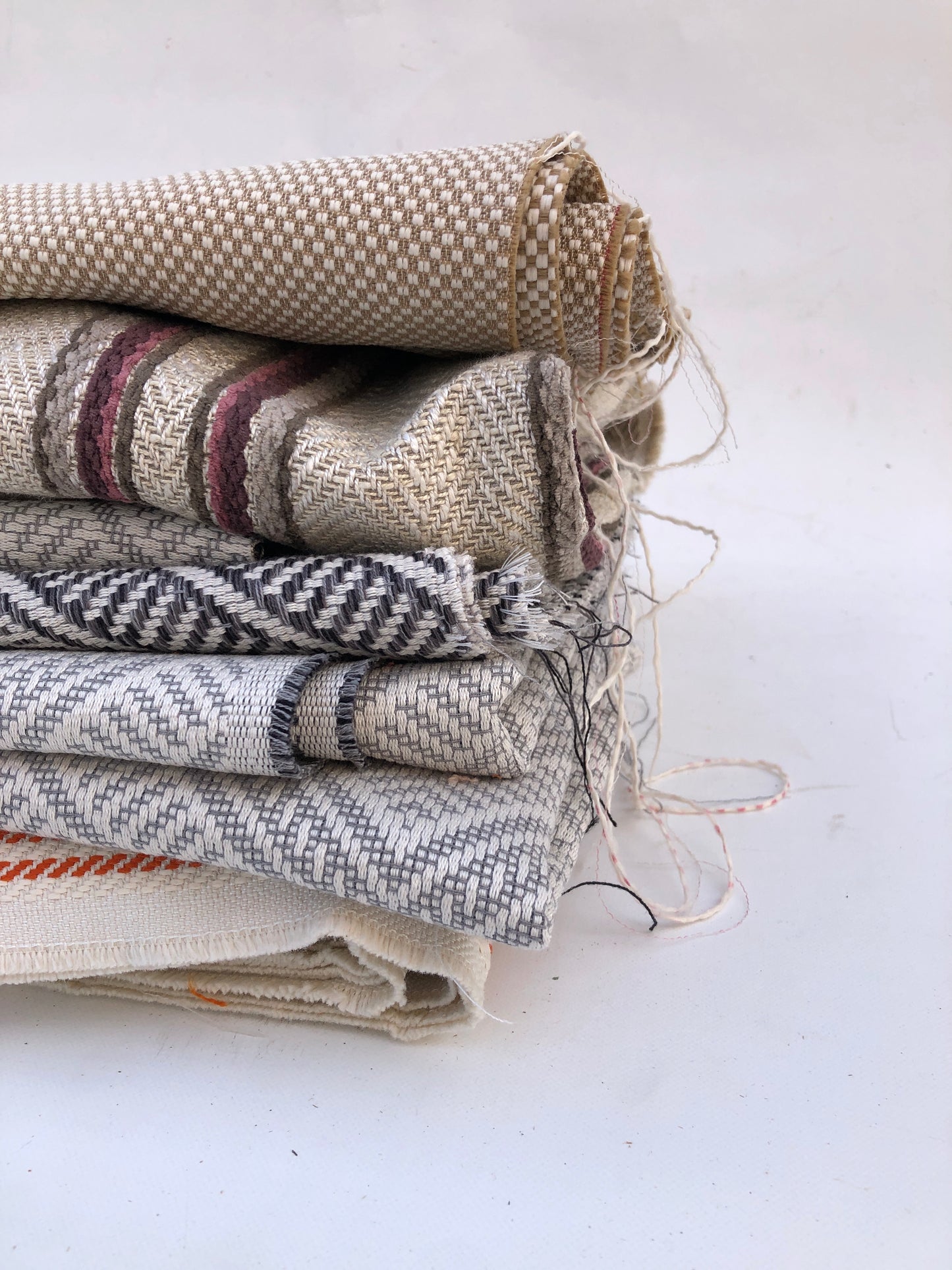Close-up of a pile of heavy weight fabric with various patterns