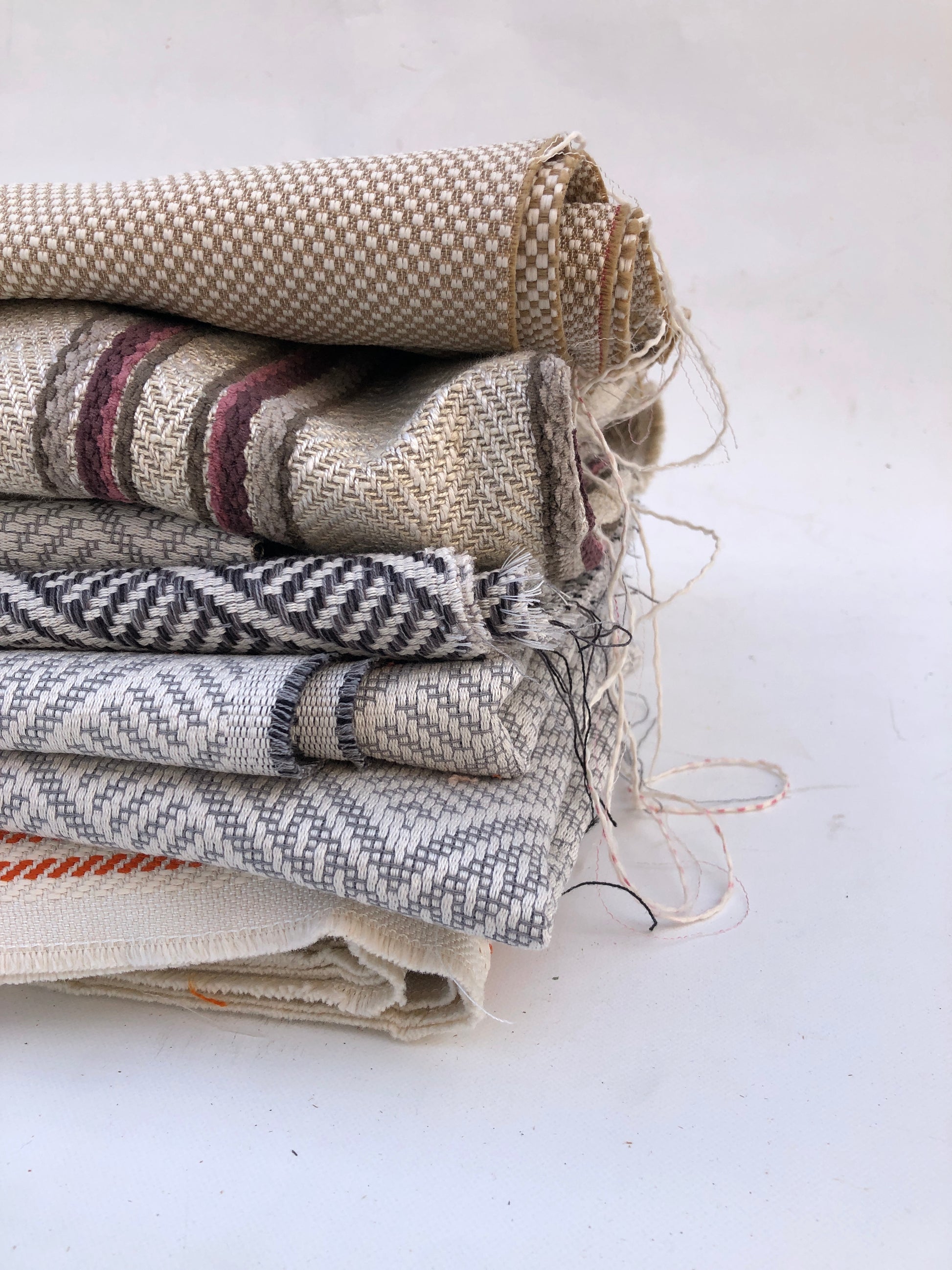 Close-up of a pile of heavy weight fabric with various patterns