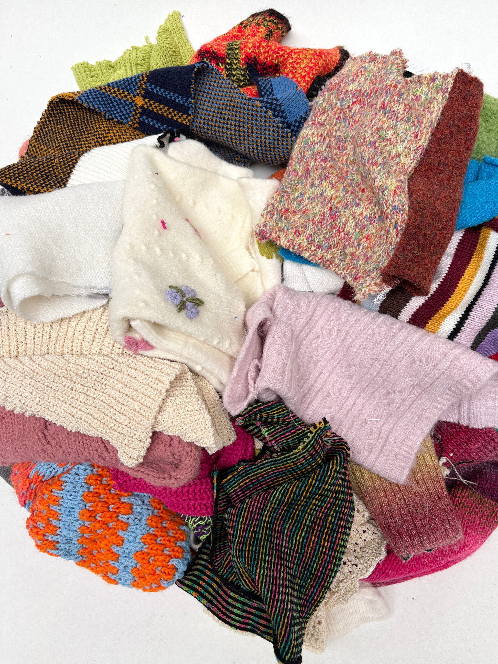 Pile of colourful knitting samples with various sizes 