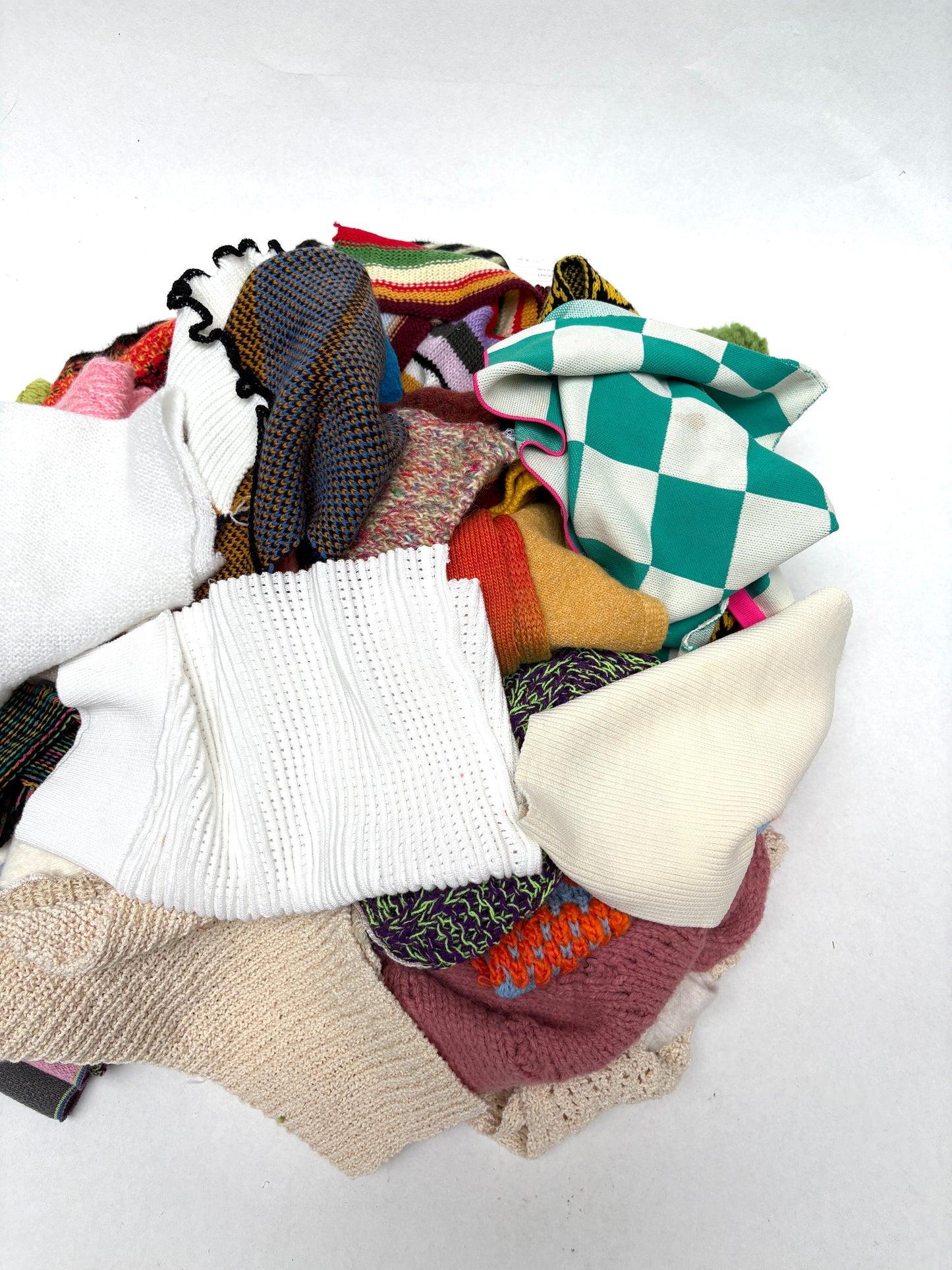 Pile of colourful knitting samples 