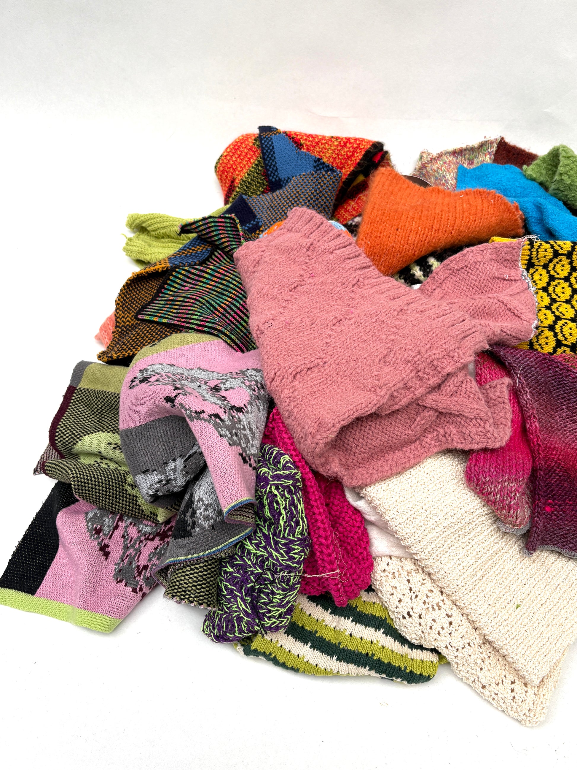 Pile of colourful knitting samples 