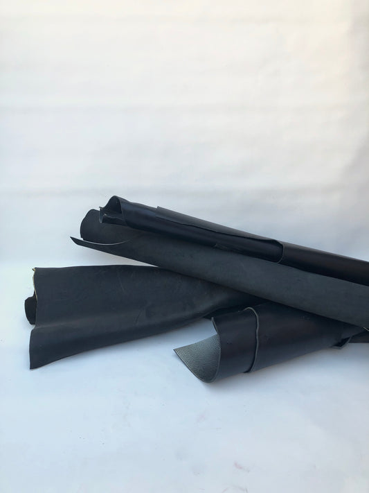 Three black rolled leather 