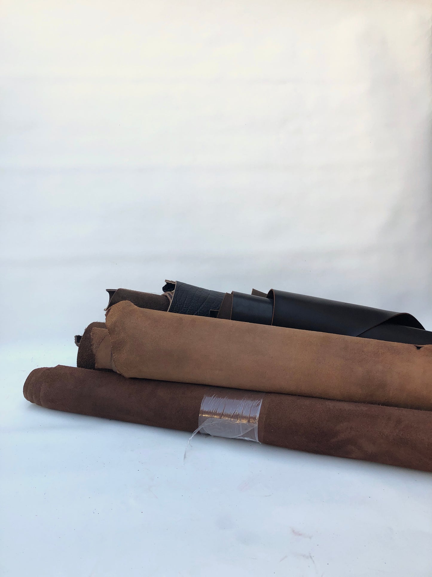 Collection of dark brown rolled leather