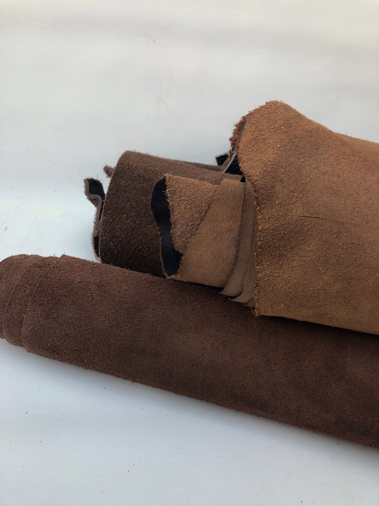 Close-up of a collection of dark brown rolled leather
