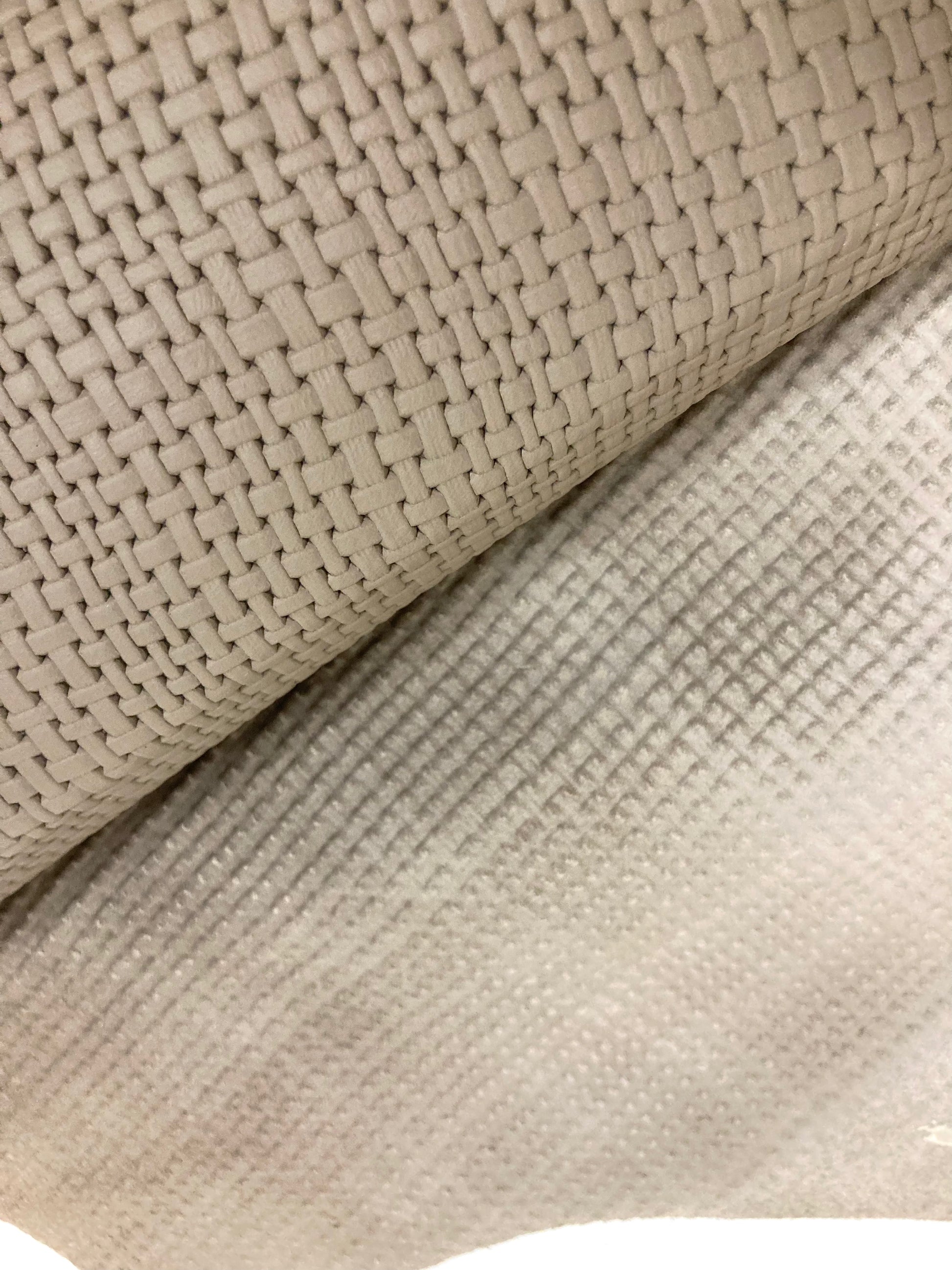 Close-up of beige rolled-up embossed leather