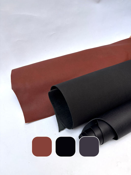 Three rolls of leather in brown, grey and black with colour swatches below.