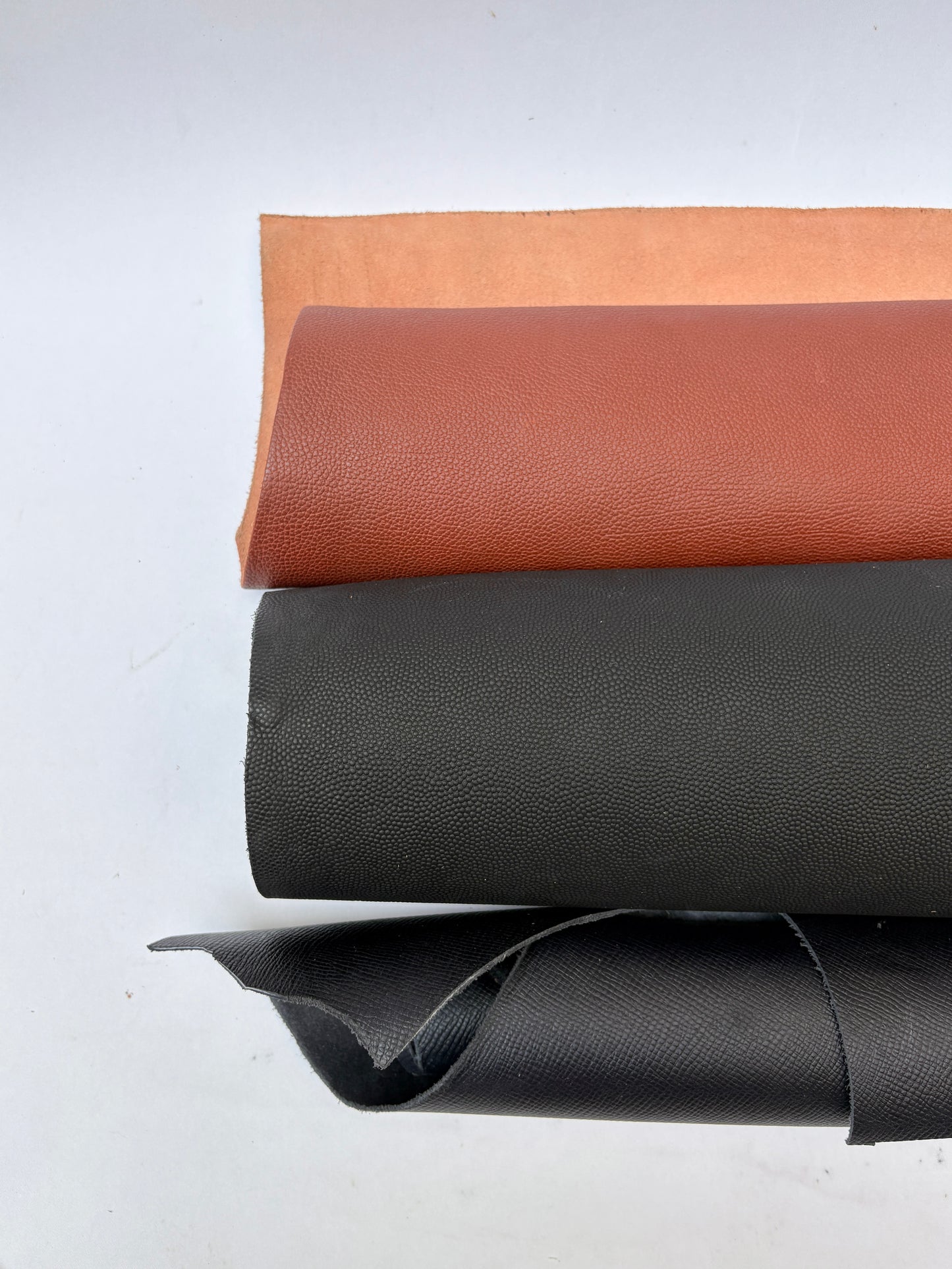 Two rolls of leather in brown and black