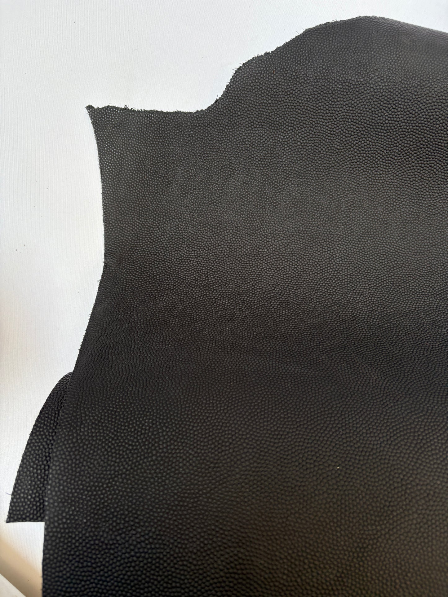 Close-up of black leather, some part had cut
