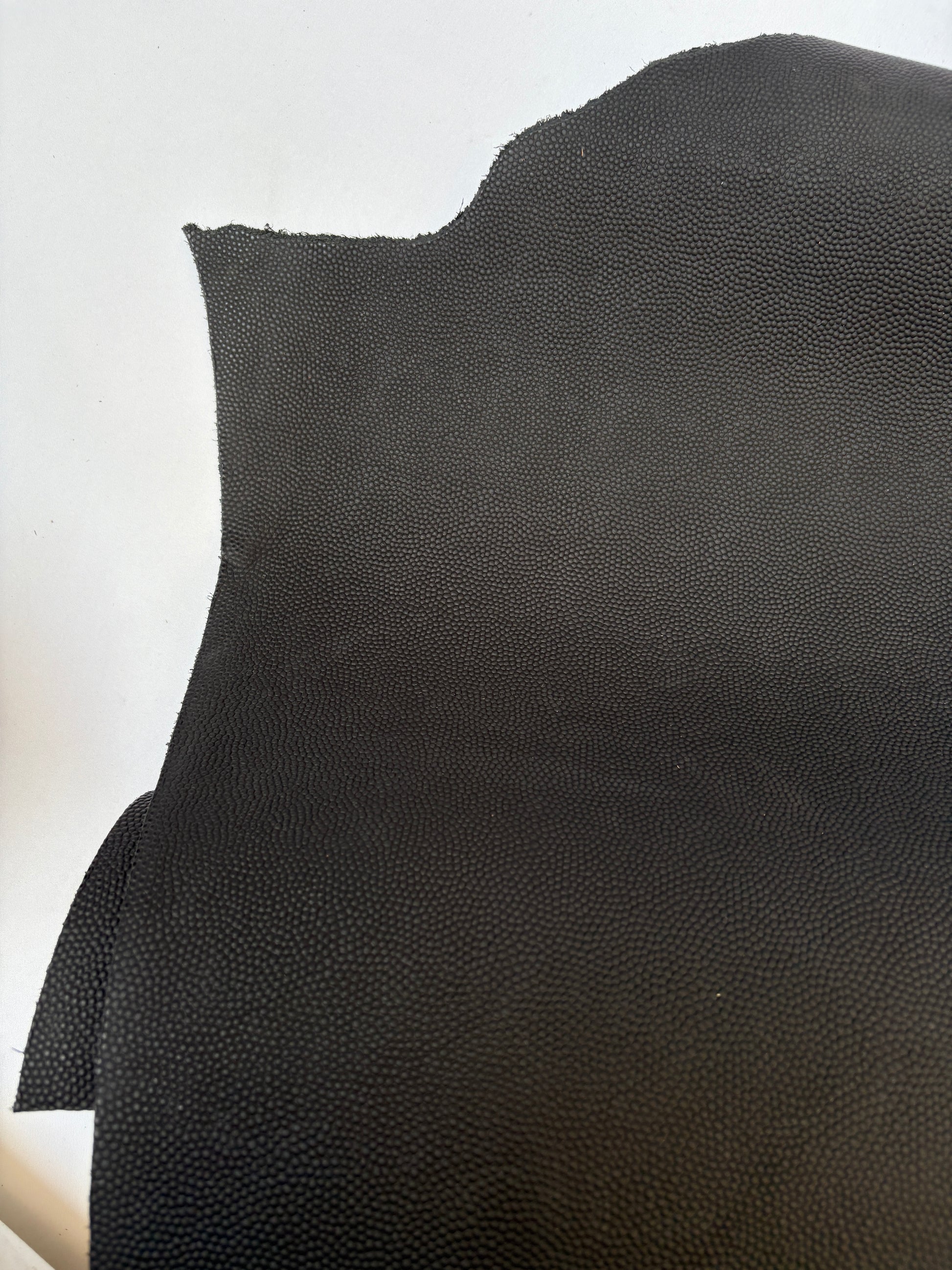 Close-up of black leather, some part had cut