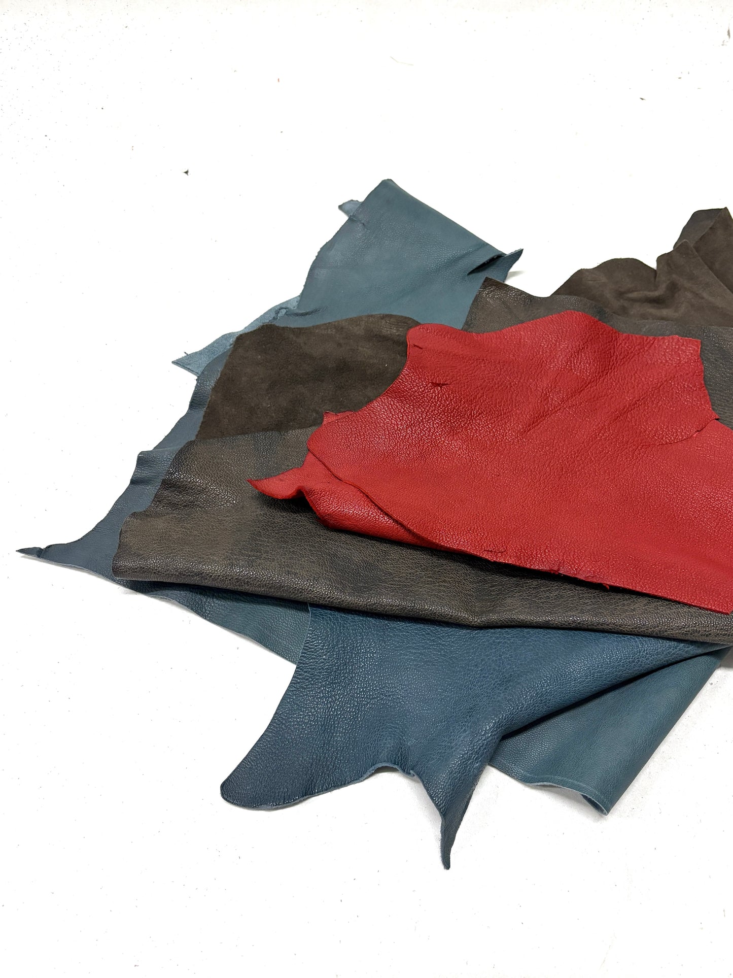 Collection of various coloured leather rolls, some have cut parts