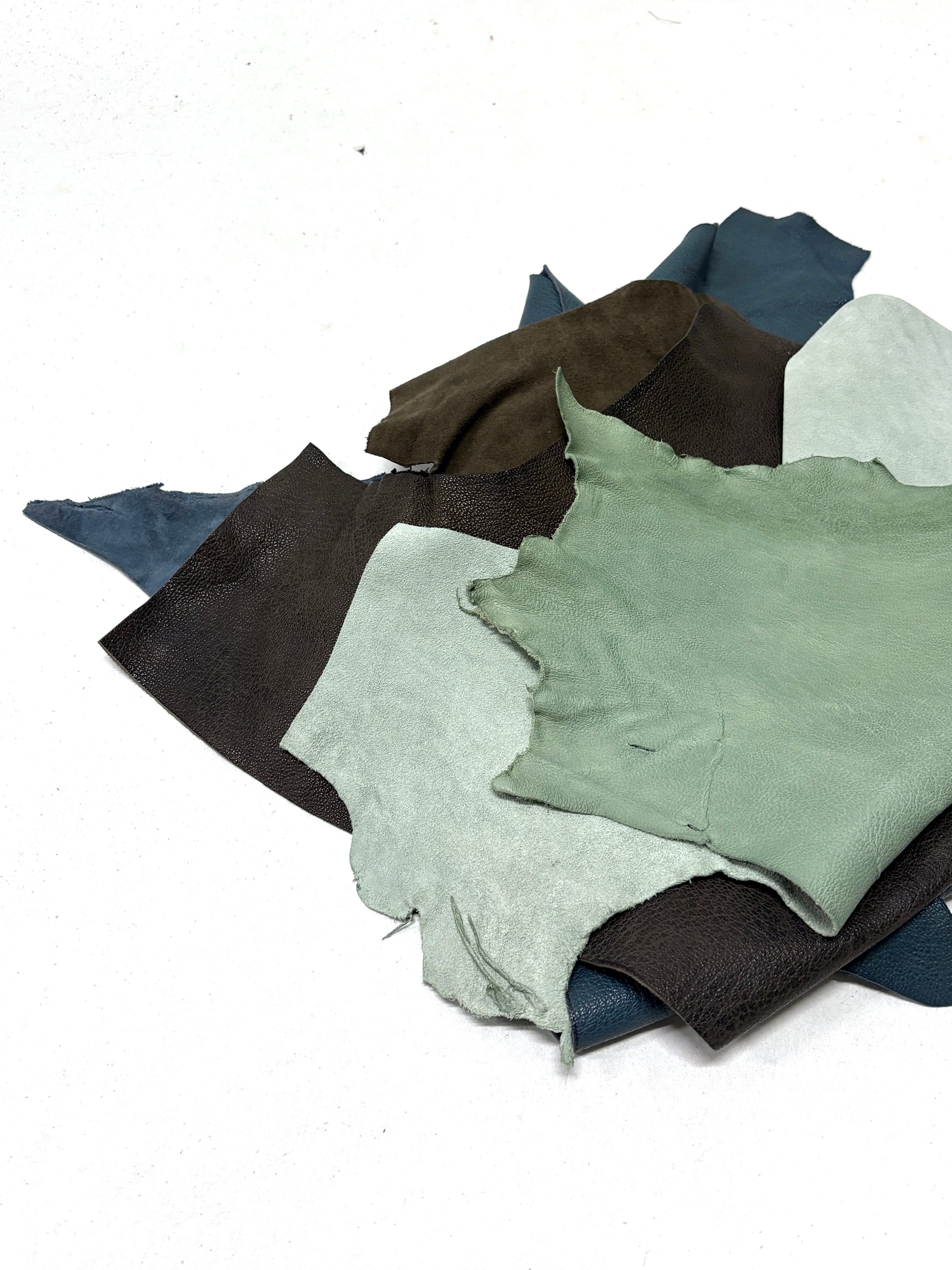 Collection of various coloured leather rolls, some have cut parts